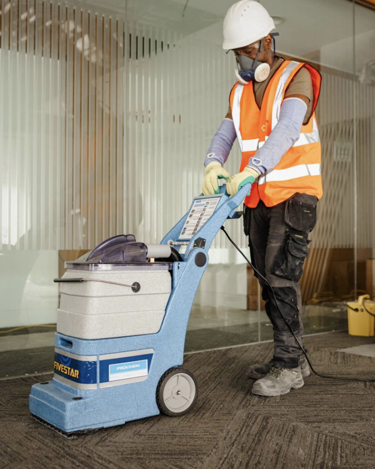 Material Reuse Group team member cleaning reclaimed carpet tiles